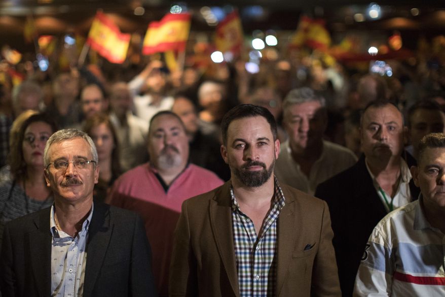 In this Wednesday, Nov. 14, 2018 photo, Spain&#x27;s far-right Vox Party President Santiago Abascal, centre, takes part in a party rally in Murcia, Spain. Vox is reaching out to the neglected, working-class suburbs and rural areas with high unemployment, as polls are widely predicting the Eurosceptic, anti-feminist and staunchly patriotic party is on track to enter the country’s parliament in elections due before 2020. (AP Photo/Emilio Morenatti)