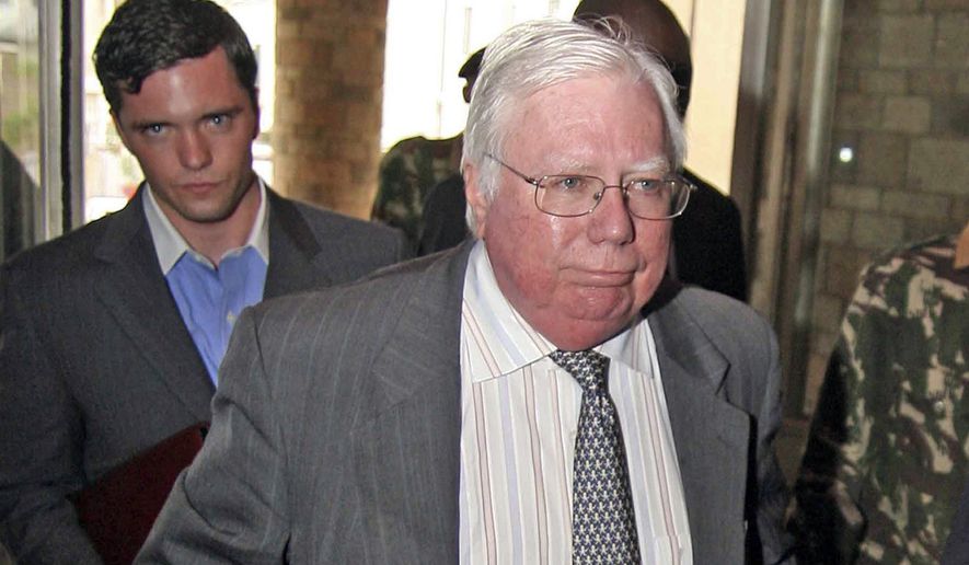 In this Oct. 7, 2008, photo, Jerome Corsi (right) arrives at the immigration department in Nairobi, Kenya. Corsi, a conservative writer and associate of President Donald Trump confidant Roger Stone says he is in plea talks with special counsel Robert Mueller’s team. Jerome Corsi told The Associated Press on Friday, Nov. 23, 2018, that he has been negotiating a potential plea but declined to comment further. (AP Photo) **FILE**