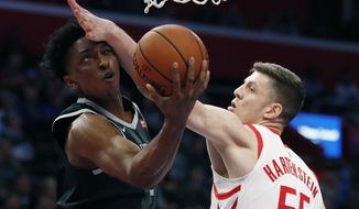 Detroit Pistons forward Stanley Johnson makes a layup as Houston Rockets forward Isaiah Hartenstein (55) defends during the first half of an NBA basketball game Friday, Nov. 23, 2018, in Detroit. (AP Photo/Carlos Osorio)