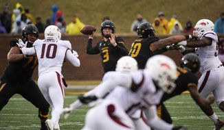 Missouri quarterback Drew Lock, center, throws a pass during the first half of an NCAA college football game against Arkansas, Friday, Nov. 23, 2018, in Columbia, Mo. (AP Photo/L.G. Patterson)