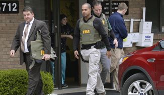 FILE - In this April 21, 2017 file photo, FBI agents leave the office of Dr. Fakhruddin Attar at the Burhani Clinic in Livonia, Mich., after completing a search for documents. A federal judge dismissed some charges Tuesday, Nov. 20, 2018, against eight people, including two doctors, in the genital mutilation of nine girls at the suburban Detroit clinic, finding it&#39;s up to states rather than Congress to regulate the practice. (Clarence Tabb Jr. /Detroit News via AP, File)