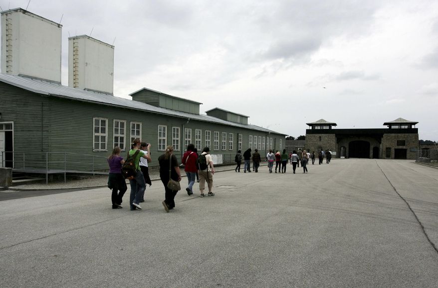 FIULE - In this June 17, 2008 file photo, young people and participants of a conference of the Task Force for International Cooperation on Holocaust Education, Remembrance and Research visit the former Nazi concentration camp in Mauthausen, Austria. A 95-year-old man has been charged with more than 36,000 counts of being an accessory to murder on allegations that he served as a guard at the Nazis' Mauthausen concentration camp, Berlin prosecutors said Friday, Nov. 23, 2018. (AP Photo/Rubra, files)