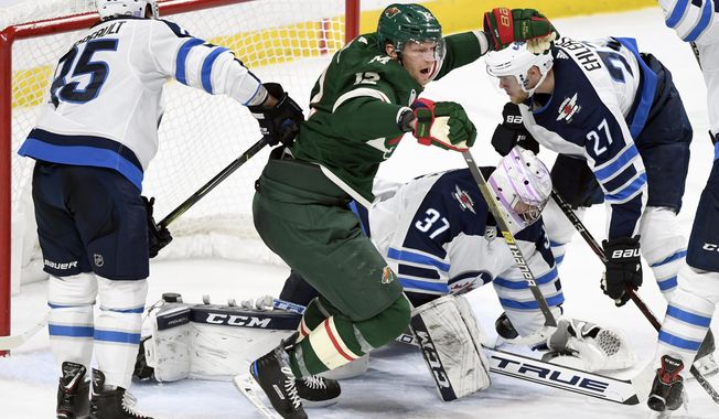 Minnesota Wild&#x27;s Eric Staal (12) celebrates a goal as Winnipeg Jets&#x27; Mathieu Perreault (85), goaltender Connor Hellebuyck (37) and Ehlers (27), of Denmark, watch during the third period of an NHL hockey game Friday, Nov. 23, 2018, in St. Paul, Minn. The Wild won 4-2. (AP Photo/Hannah Foslien)