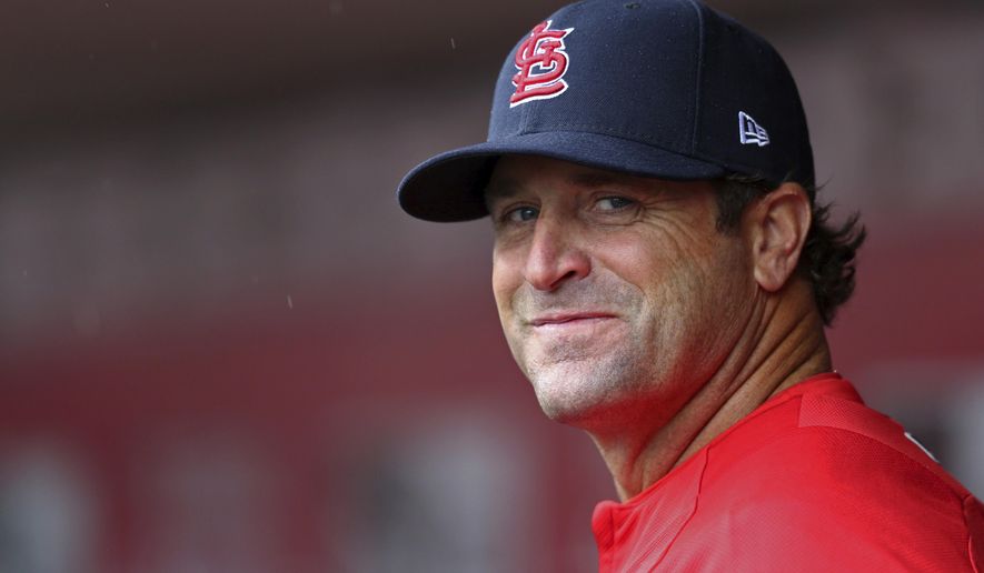 File-This April 14, 2018, file photo shows former St. Louis Cardinals&#x27; manager Mike Matheny standing in the dugout in the first inning of a baseball game against the Cincinnati Reds in Cincinnati. Matheny was hired by Kansas City as a special adviser for player development, putting the former St. Louis Cardinals manager in position as a possible successor to Royals manager Ned Yost. (AP Photo/Aaron Doster, File)
