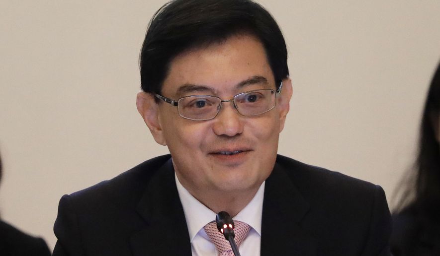 FILE - In this April 6, 2018, file photo, Singapore's Finance Minister Heng Swee Keat delivers his opening address at the start of the ASEAN Finance Ministers' Meetings in Singapore. Singapore's ruling party has promoted Heng to No. 2 post, making him a likely choice to succeed the prime minister. Prime Minister Lee Hsien Loong has said he hopes to step down in four years. (AP Photo/Wong Maye-E, File)