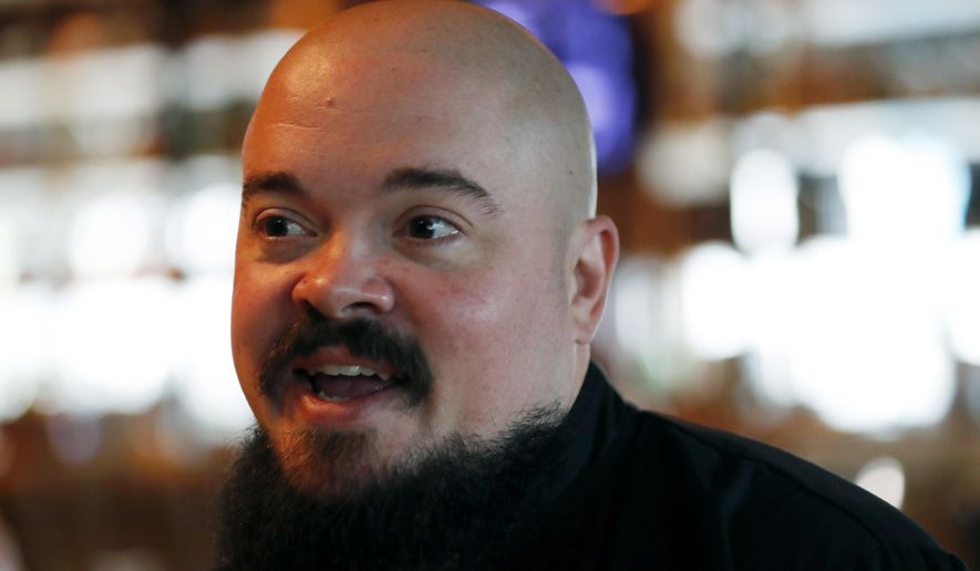 In this Tuesday, Nov. 13, 2018 photo, Chef Isaac Toups speaks during an interview with The Associated Press in his restaurant Toups Meatery in New Orleans. Toups is celebrating the Cajun cooking he grew up with in his first cookbook. “Chasing the Gator: Isaac Toups and the New Cajun Cooking” is a treatise on Cajun cooking laced with personal stories by Toups about his culinary upbringing. Toups, who hails from Cajun country - a region of south Louisiana settled by French people evicted from Canada, has two restaurants in New Orleans. (AP Photo/Gerald Herbert)