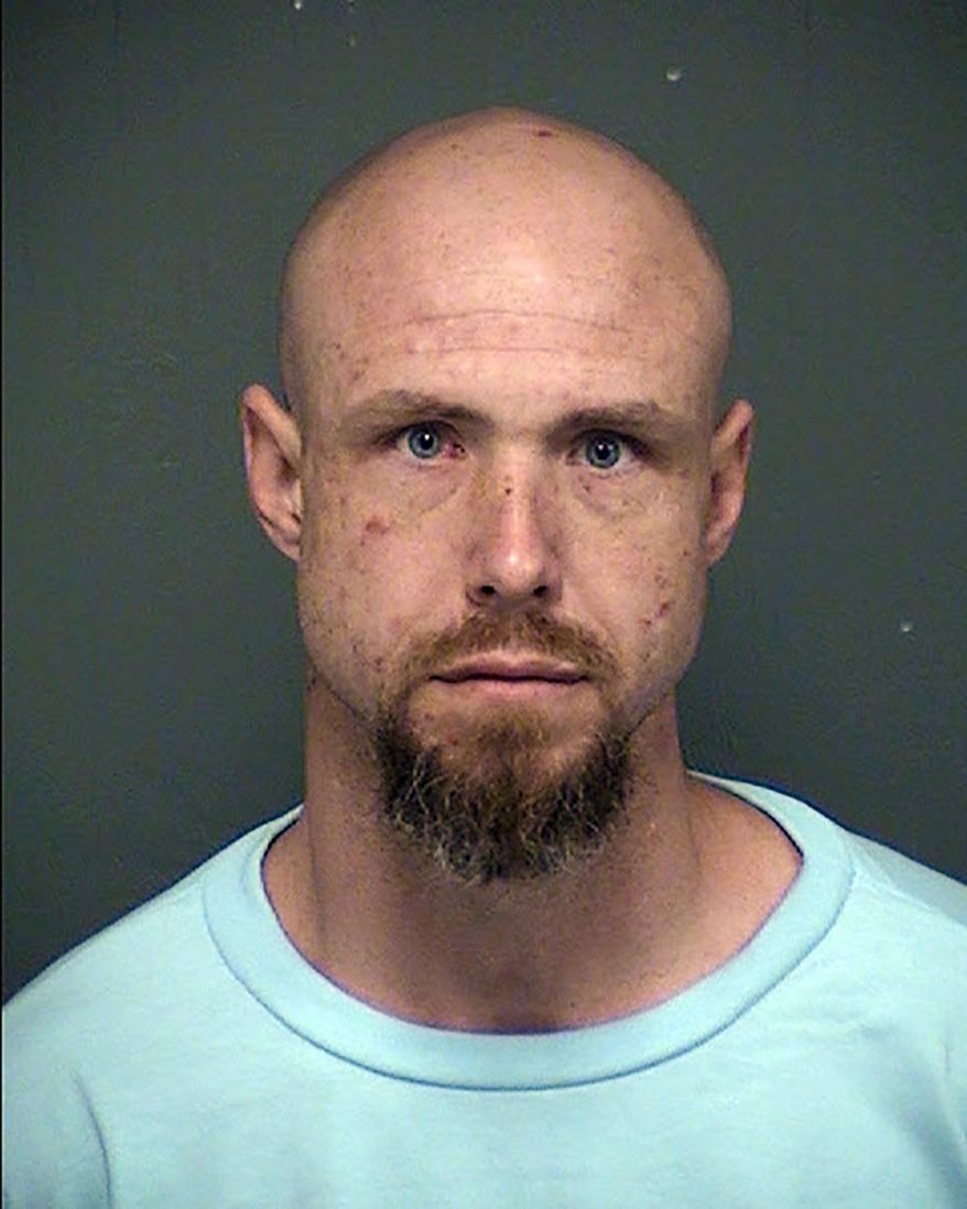 This undated booking photo released by the Tucson Police Department shows arrested man David James Bohart. Tucson police say Bohart was released from the Tucson state prison complex Monday, Nov. 19, 2018, and is accused of killing a woman the same day. Police say Bohart was arrested at a hotel Friday, Nov. 23, on suspicion of second-degree murder in the killing of 49-year-old Marika L. Jones at a Tucson home. Bohart remained jailed Saturday and online court records don't list an attorney who could comment on his behalf. (Tucson Police Department via AP)