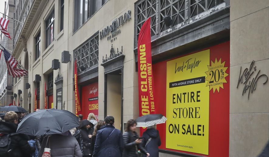 In this Friday, Nov. 9, 2018 photo, closeout sale signs cover windows that annually attracted holiday shoppers and tourists with spectacular Christmas season displays at Lord &amp;amp; Taylor department store in New York. Lord &amp;amp; Taylor plans to close its longtime Fifth Avenue flagship in January 2019 after one last blowout sale. The demise of the Fifth Avenue store fits into the bigger picture of a shifting economy in which brick-and-mortar retail has taken a hit from online sales. (AP Photo/Bebeto Matthews)