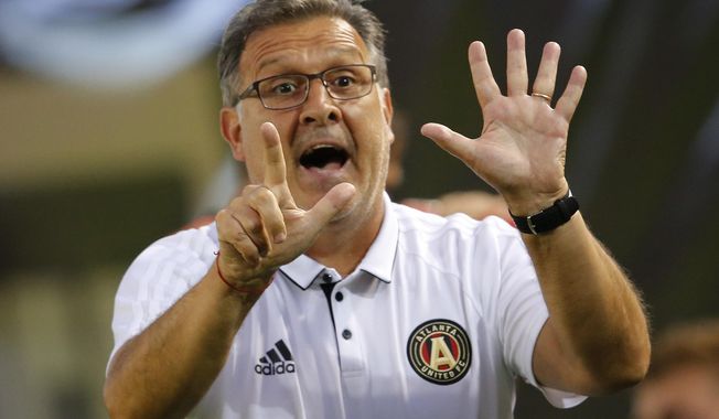 FILE - In this June 17, 2017, file photo, Atlanta United head coach Gerardo &amp;quot;Tata&amp;quot; Martino signals to his players in the second half of an MLS soccer match against the Columbus Crew in Atlanta. The New York Red Bulls and Atlanta United are clearly the two best teams in Major League Soccer These two powerhouses will meet in a two-leg Eastern Conference final, which begins Sunday night before another expected crowd of more than 70,000 at Mercedes-Benz Stadium. The second game will be held Thursday night in Harrison, N.J. (AP Photo/John Bazemore, File)