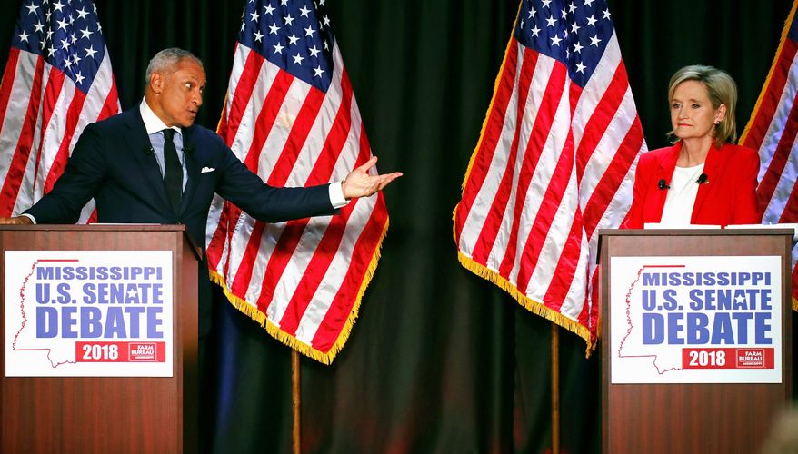 Democrat Mike Espy challenges an answer from rival appointed Sen. Cindy Hyde-Smith during a recent debate. President Trump will be in Mississippi on Monday to support Ms. Hyde-Smith's campaign. (Associated Press)