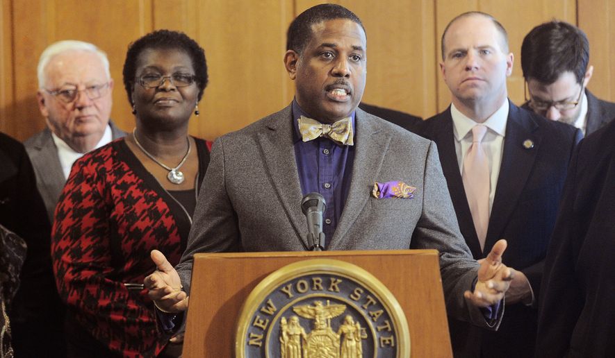 Sen. Kevin Parker, D- Brooklyn, stands with Senate members announcing that they are working on legislation to make voting easier for New Yorkers, during a news conference at the Capitol, Monday, Feb. 6, 2017, in Albany, N.Y. (AP Photo/Hans Pennink)