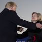 President Donald Trump embraces Sen. Cindy Hyde-Smith, R-Miss., during a rally at Tupelo Regional Airport, Monday, Nov. 26, 2018, in Tupelo, Miss. (AP Photo/Alex Brandon)