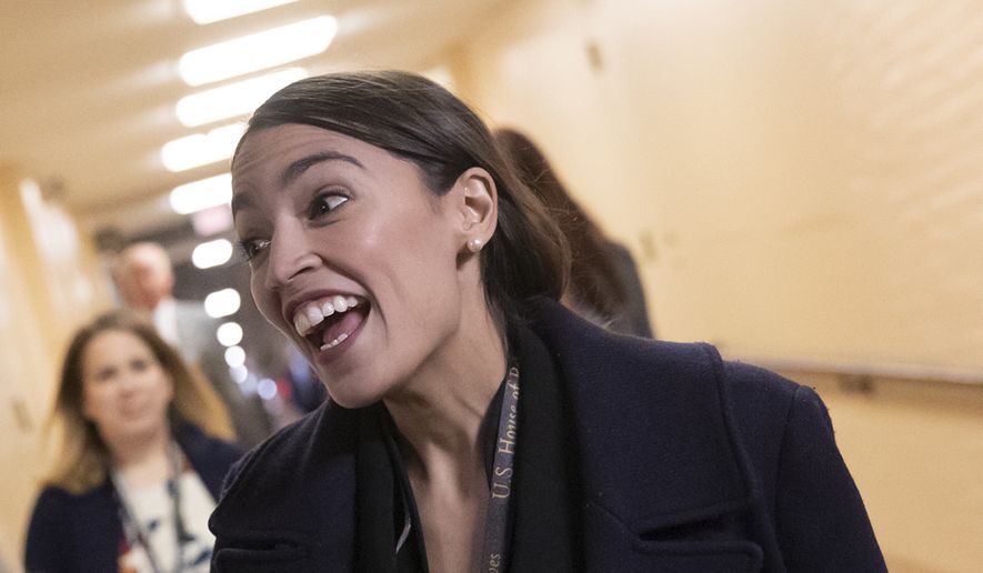 In this photo taken in Washington, Thursday, Nov. 15, 2018, Rep.-elect Alexandria Ocasio-Cortez, D-N.Y., smiles as as new members of the House and veteran representatives gather behind closed doors to discuss their agenda when they become the majority in the 116th Congress. (AP Photo/J. Scott Applewhite) ** FILE **