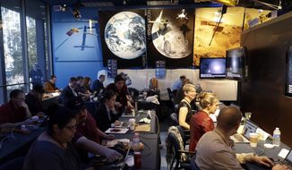 Journalists gather at NASA&#x27;s Jet Propulsion Laboratory awaiting the landing of InSight on Mars Monday, Nov. 26, 2018, in Pasadena, Calif . A NASA spacecraft is just a few hours away from landing on Mars. The InSight lander is aiming for a Monday afternoon touchdown on what scientists and engineers hope will be a flat plain on the red planet. (AP Photo/Marcio Jose Sanchez) **FILE**