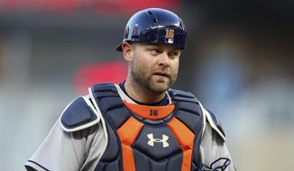 FILE- In this April 10, 2018, file photo, Houston Astros catcher Brian McCann watches in the first inning of a baseball game against the Minnesota Twins  in Minneapolis. A person familiar with the negotiations tells The Associated Press that McCann has agreed to return to the Atlanta Braves for a $2 million, one-year contract. The person spoke on condition of anonymity Monday, Nov. 26, 2018, because the agreement had not yet been announced. (AP Photo/Jim Mone, File) **FILE**