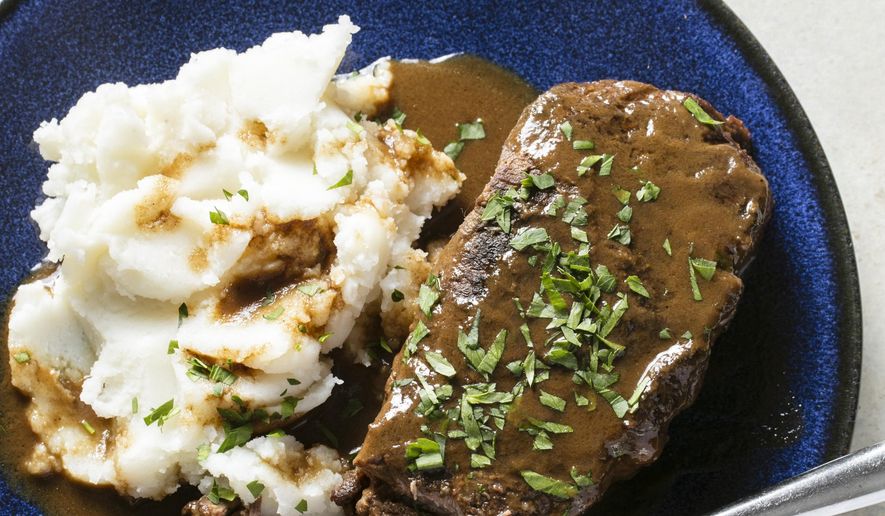 This undated photo provided by America's Test Kitchen in November 2018 shows a short rib “pot roast” paired with mashed potatoes in Boston. (Steve Klise/America's Test Kitchen via AP)