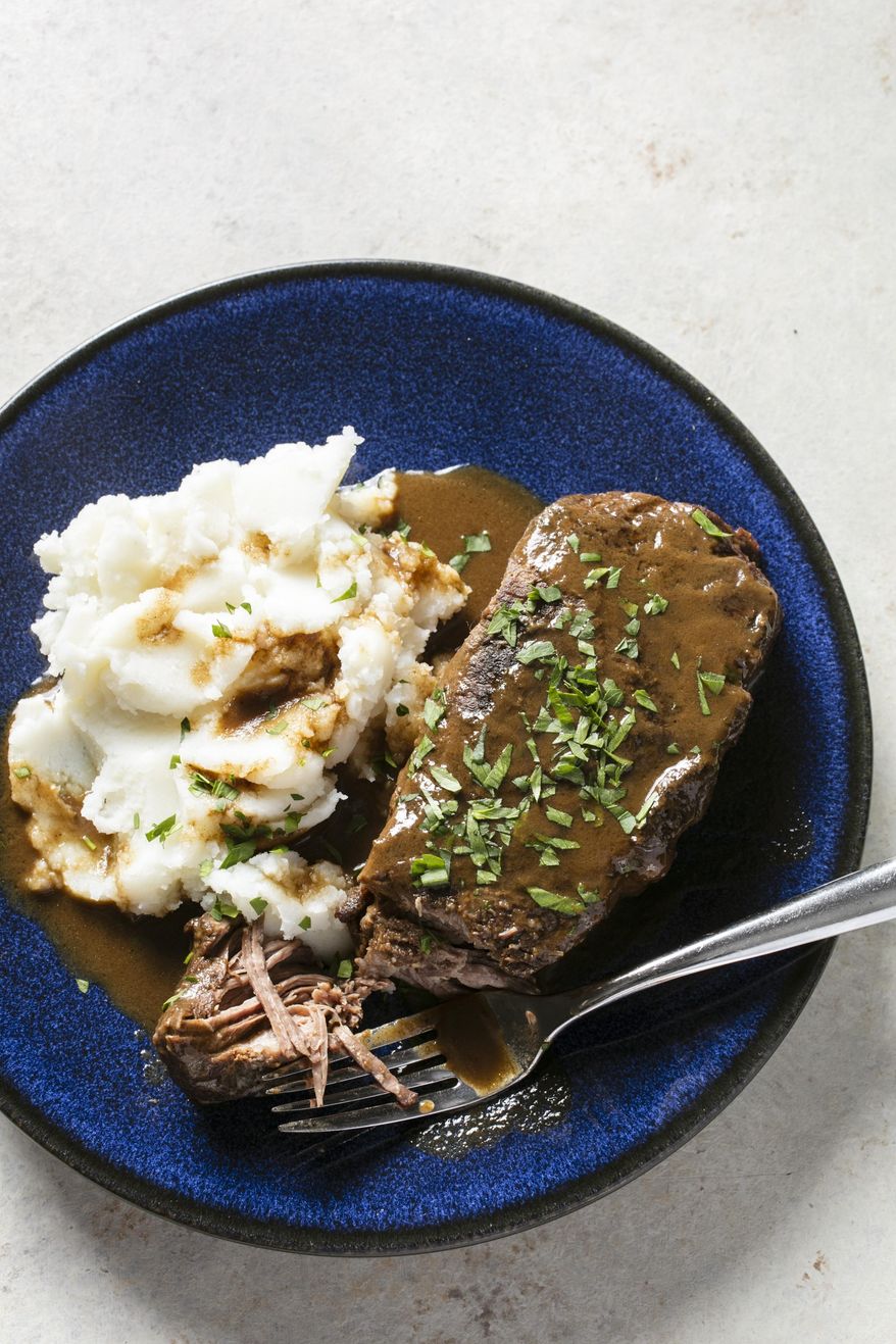 This undated photo provided by America's Test Kitchen in November 2018 shows a short rib “pot roast” paired with mashed potatoes in Boston. (Steve Klise/America's Test Kitchen via AP)