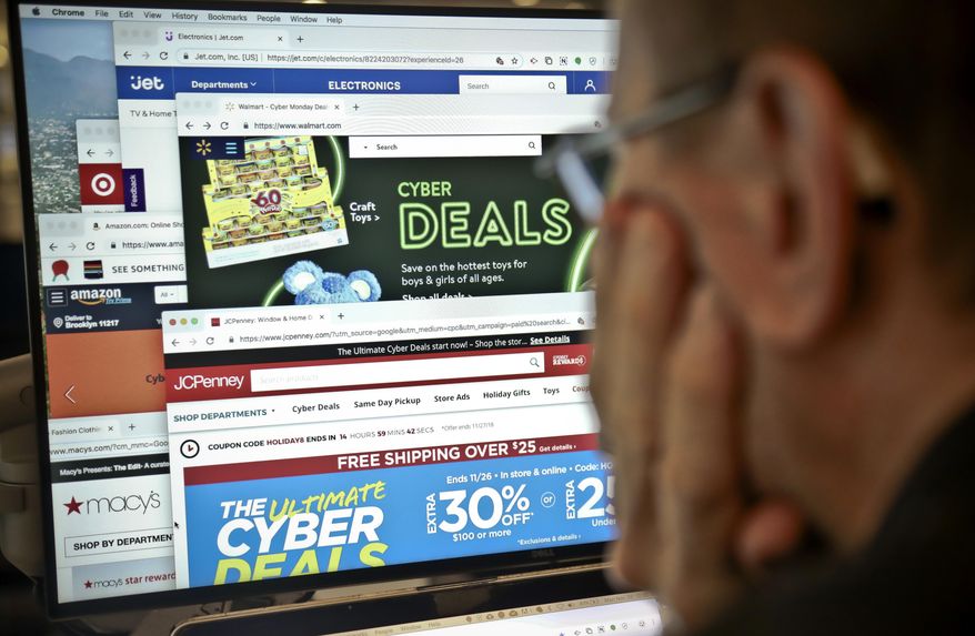 A journalist looks at a computer screen with webpages arranged to show Cyber Monday deals by various online retailers Monday Nov. 26, 2018, in New York. The physical rush of Black Friday and the armchair browsing of Cyber Monday are increasingly blending into one big holiday shopping event as more customers buy items online and pick them up at brick-and-mortar stores. (AP Photo/Bebeto Matthews) **FILE**