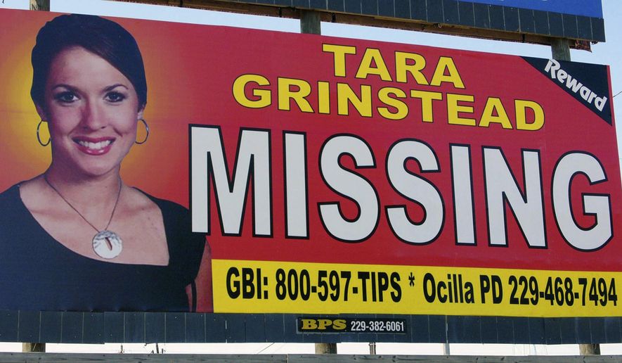 FILE - In this Oct. 4, 2006, file photo, teacher Tara Grinstead is displayed on a billboard in Ocilla, Ga. A hearing has been set to determine how a case will proceed against two men accused in the slaying a high school teacher who vanished 13 years ago. The Monday, Nov. 26, 2018, hearing will determine if most charges should be dropped against the men because too much time has passed since former beauty queen Tara Grinstead’s disappearance. (AP Photo/Elliott Minor, File)