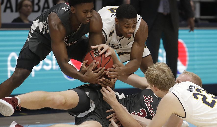 Santa Clara&#39;s Trey Wertz, top left, and Henrik Jadersten (3) wrestle for the ball against California&#39;s Paris Austin, top right, and Connor Vanover (23) during the second half of an NCAA college basketball game in Berkeley, Calif., Monday, Nov. 26, 2018. (AP Photo/Jeff Chiu)