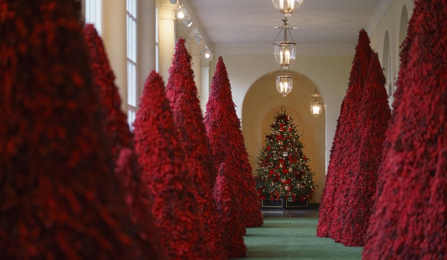 Topiary trees line the East colonnade during the 2018 Christmas Press Preview at the White House in Washington, Monday, Nov. 26, 2018. Christmas has arrived at the White House. First lady Melania Trump unveiled the 2018 White House holiday decor on Monday. She designed the decor, which features a theme of &amp;quot;American Treasures.&amp;quot; (AP Photo/Carolyn Kaster)