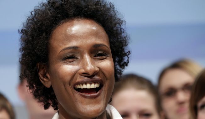 Model Waris Dirie from Somalia smiles after the presentation of the human rights logo competition in Berlin, Germany, Tuesday, May 3, 2011.  (AP Photo/Michael Sohn)