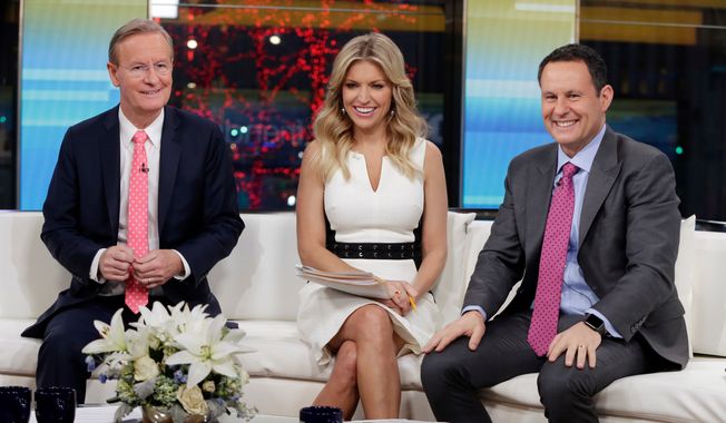 In this Jan. 17, 2018, file photo, &quot;Fox &amp; Friends&quot; co-hosts, from left, Steve Doocy, Ainsley Earhardt and Brian Kilmeade appear on their set in New York. (AP Photo/Richard Drew, File)
