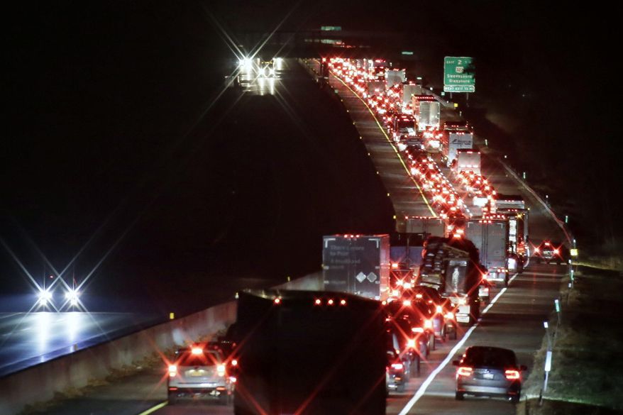 Southbound traffic on the New Jersey Turnpike is backed up before Exit 2 as drivers had to exit there because the Delaware Memorial Bridge was closed in both directions, Sunday night, Nov. 25, 2018, near Swedesboro, N.J. A chemical leak shut down the bridge, bringing traffic on a major East Coast artery to a standstill on one of the busiest travel days of the year. (Elizabeth Robertson/The Philadelphia Inquirer via AP)
