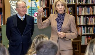 Sen. Lamar Alexander listens as Department of Education Secretary Betsy DeVos speaks to students at Sevier County High School, Tuesday, Nov. 13, 2018, in Sevierville, Tenn. The pair spoke about the newly launched myStudentAid mobile application. (Robert Berlin/The Daily Times via AP)