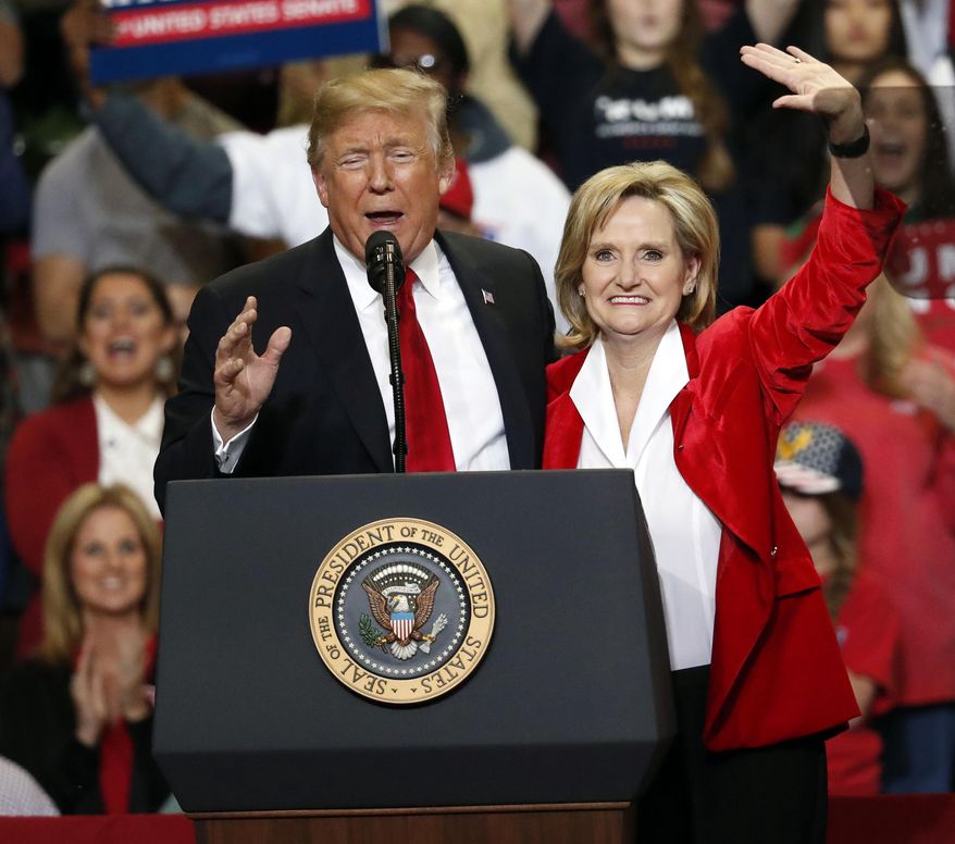President Donald Trump encourages voters to support appointed Republican U.S. Sen. Cindy Hyde-Smith in a runoff race Tuesday against Democrat Mike Espy, as he speaks during a rally Monday, Nov. 26, 2018, in Biloxi, Miss. (AP Photo/Rogelio V. Solis)