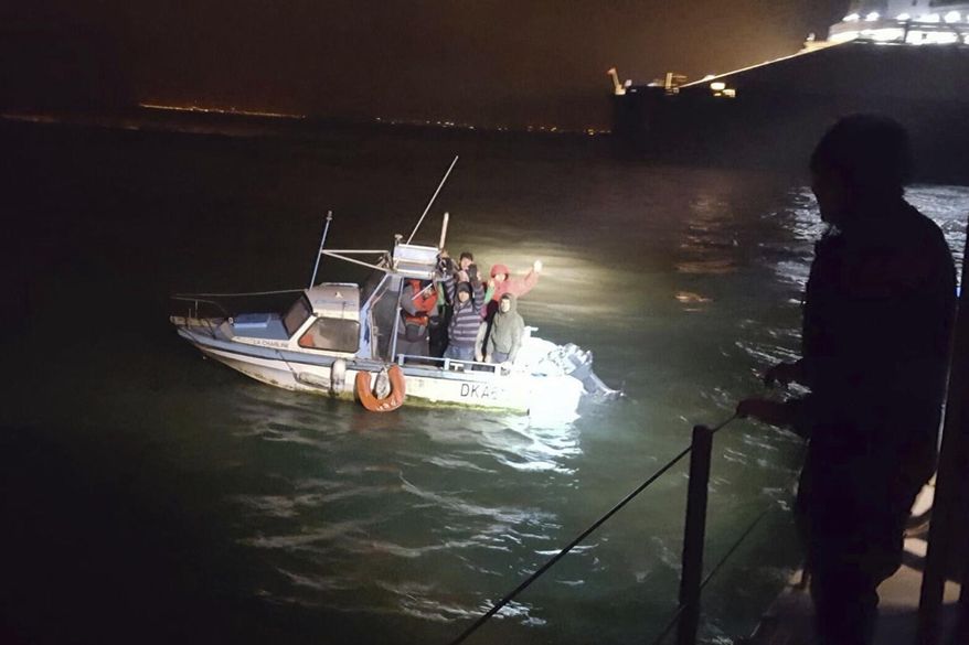 This image provided by the Gendarmerie Maritime (French Coast Guard) shows migrants aboard a boat after being intercepted by French authorities, off the port of Dunkirk, northern France, Tuesday, Nov. 27, 2018. French and British maritime authorities have pulled 18 migrants in two small boats from the English Channel as they tried to get to Britain, the latest of several recent rescues. (Gendarmerie Maritime via AP)