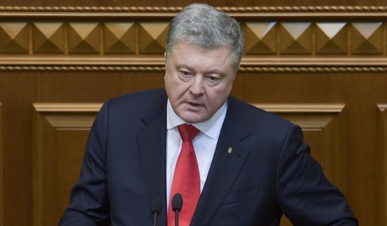 Ukrainian President Petro Poroshenko gestures during a parliament session in Kiev, Ukraine, Monday, Nov. 26, 2018. Ukraine&#39;s president on Monday urged parliament to impose martial law in the country to fight &amp;quot;growing aggression from Russia,&amp;quot; after a weekend naval confrontation off the disputed Crimean Peninsula in which Russia fired on and seized three Ukrainian vessels amid renewed tensions between the neighbors. (Mykola Lazarenko, Presidential Press Service via AP)