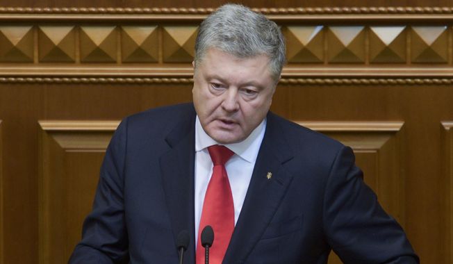 Ukrainian President Petro Poroshenko gestures during a parliament session in Kiev, Ukraine, Monday, Nov. 26, 2018. Ukraine&#x27;s president on Monday urged parliament to impose martial law in the country to fight &amp;quot;growing aggression from Russia,&amp;quot; after a weekend naval confrontation off the disputed Crimean Peninsula in which Russia fired on and seized three Ukrainian vessels amid renewed tensions between the neighbors. (Mykola Lazarenko, Presidential Press Service via AP)
