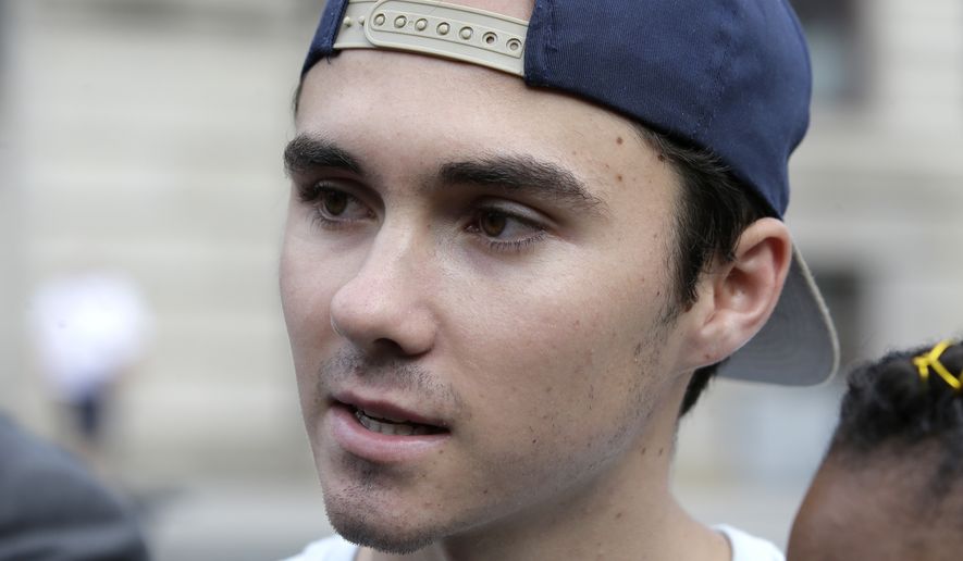 David Hogg, a survivor of the school shooting at Marjory Stoneman Douglas High School, in Parkland, Florida, speaks with reporters before walking in a planned 50-mile march, Thursday, Aug. 23, 2018, in Worcester, Mass. The march, held to call for gun law reforms, began Thursday, in Worcester, and is scheduled to end Sunday, Aug. 26, 2018, in Springfield, Mass., at the headquarters of gun manufacturer Smith &amp; Wesson. (AP Photo/Steven Senne)