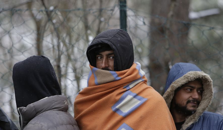 Migrants wait for food distribution in Bihac, Bosnia, close to the border to Croatia on Wednesday, Nov. 28, 2018. The approach of the tough Balkan winter spells tough times for the migrants that remain stuck in the region while trying to reach Western Europe, with hundreds of them staying in make-shift camps with no heating or facilities. (AP Photo/Amel Emric)