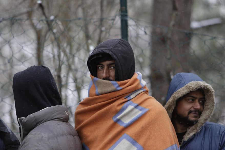 Migrants wait for food distribution in Bihac, Bosnia, close to the border to Croatia on Wednesday, Nov. 28, 2018. The approach of the tough Balkan winter spells tough times for the migrants that remain stuck in the region while trying to reach Western Europe, with hundreds of them staying in make-shift camps with no heating or facilities. (AP Photo/Amel Emric)