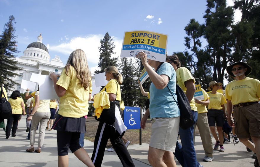 In this Sept. 24, 2015, photo, supporters of a measure to allow terminally ill people to end their own life march at the Capitol in Sacramento, Calif. A California appeals court overturned a lower court ruling that found the state's assisted suicide law was unconstitutional. A panel of the Fourth District Court of Appeals in Riverside on Tuesday, Nov. 27, 2018, said doctors who brought the case did not show they were harmed because they could choose not to help terminally ill patients die. (AP Photo/Rich Pedroncelli) **FILE**