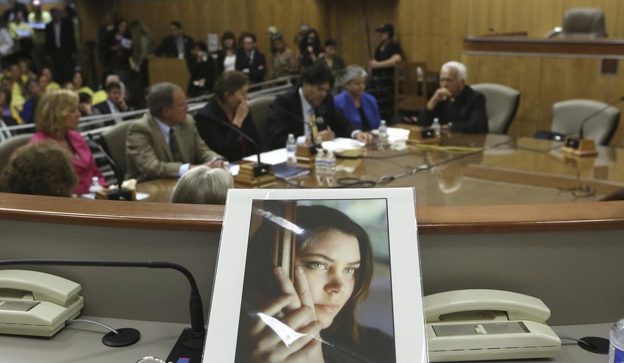 FILE - In this March 25, 2015, file photo, a portrait of Brittany Maynard sits on the dais of the Senate Health Committee at the Capitol in Sacramento, Calif., as lawmakers took testimony on proposed legislation allowing doctors to prescribe life ending medication to terminally ill patients. A California appeals court overturned a lower court ruling that found the state's assisted suicide law was unconstitutional, Tuesday, Nov. 27, 2018. Maynard, who was dying from brain cancer, had to move to Oregon in 2014 so she could end her life. (AP Photo/Rich Pedroncelli, File)