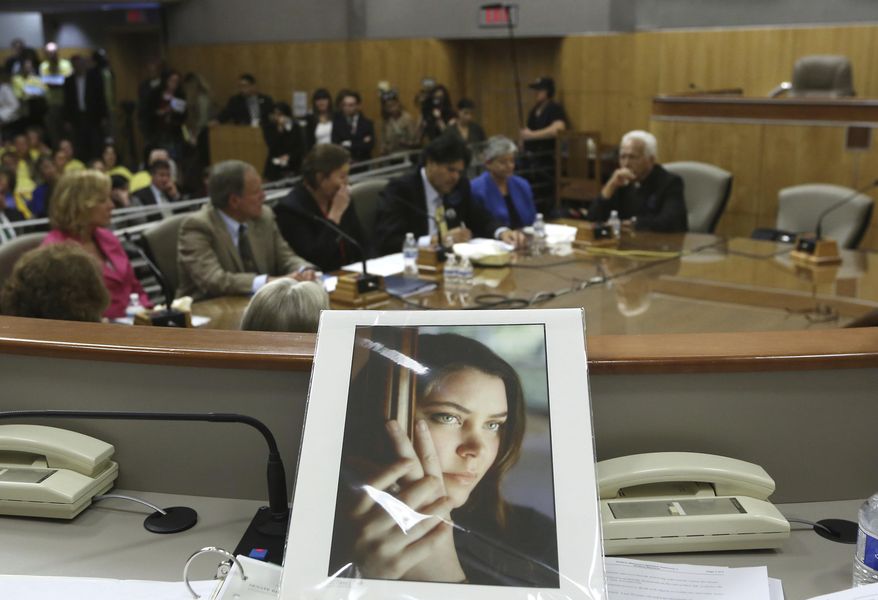 FILE - In this March 25, 2015, file photo, a portrait of Brittany Maynard sits on the dais of the Senate Health Committee at the Capitol in Sacramento, Calif., as lawmakers took testimony on proposed legislation allowing doctors to prescribe life ending medication to terminally ill patients. A California appeals court overturned a lower court ruling that found the state's assisted suicide law was unconstitutional, Tuesday, Nov. 27, 2018. Maynard, who was dying from brain cancer, had to move to Oregon in 2014 so she could end her life. (AP Photo/Rich Pedroncelli, File)
