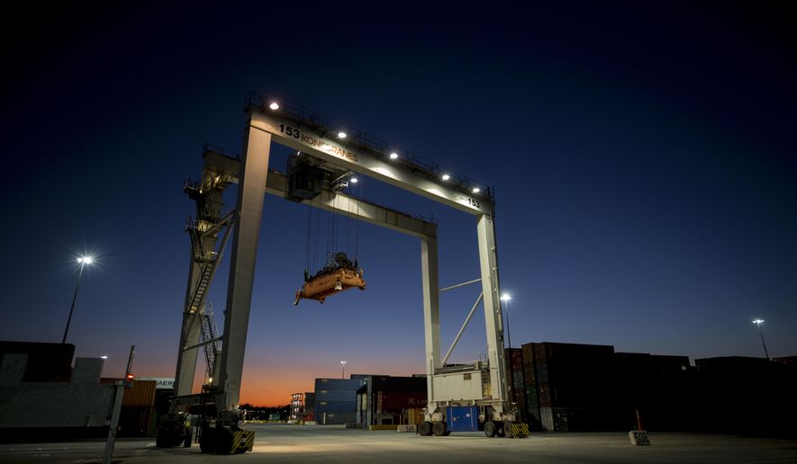 FILE- In this Jan. 30, 2018, file photo a rubber tire gantry moves into position to transfer shipping containers at the Georgia Ports Authority's Port of Savannah in Savannah, Ga. On Wednesday, Nov. 28, the Commerce Department issues the final estimate of how the U.S. economy performed in the July-September quarter. (AP Photo/Stephen B. Morton, File)