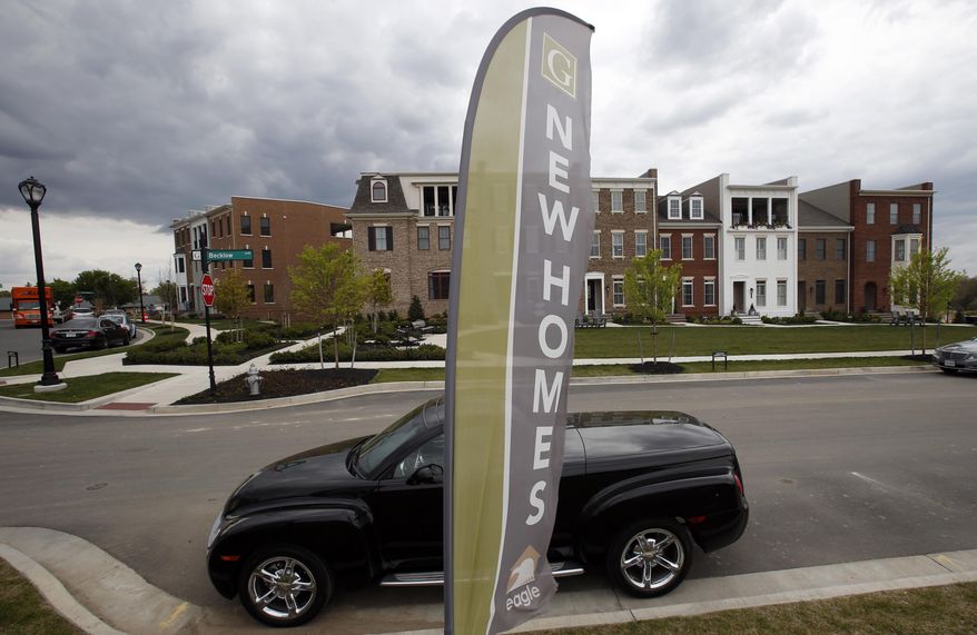 FILE- In this April 23, 2018, file photo advertising signs point out completed new homes, homes under construction as well as lots for new homes in Glen Allen, Va. On Wednesday, Nov. 28, the Commerce Department reports on sales of new homes in October. (AP Photo/Steve Helber, File)