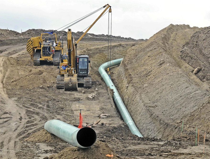 FILE - In this Oct. 5, 2016, file photo, heavy equipment is seen at a site where sections of the Dakota Access pipeline were being buried near the town of St. Anthony in Morton County, N.D. The Texas-based developer of the Dakota Access oil pipeline says it has complied with terms of a 2017 agreement settling allegations it violated North Dakota rules during construction, though state regulators are seeking more information. Energy Transfer Partners was accused of removing too many trees and improperly handling a pipeline route change after discovering Native American artifacts. (Tom Stromme/The Bismarck Tribune via AP, File)