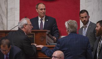 FILE - In this Aug. 20, 2018 file photo, Senate President Mitch Carmichael discusses the details of a proposed amendment with Michael A. Woelfel, D-Cabell, center, and Charles S. Trump IV, R-Morgan, left, during a special session to begin impeachment proceedings against state Supreme Court Justices Allen Loughry, Beth Walker and Chief Justice Margaret Workman at the Capitol building in Charleston, W.Va. Carmichael is mulling his options after the state Supreme Court refused to revisit a ruling that halted the impeachment process of several justices. A panel of judicial stand-ins ruled Oct. 11, 2018, in favor of Justice Workman&#39;s challenge of her impeachment. (Craig Hudson/Charleston Gazette-Mail via AP, File)