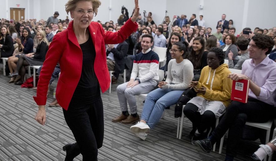 Sen. Elizabeth Warren, D-Mass., waves as she departs after speaking at the American University Washington College of Law in Washington, Thursday, Nov. 29, 2018, on her foreign policy vision for the country. (AP Photo/Andrew Harnik)