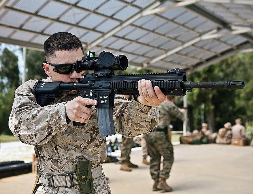 M27 infantry automatic rifle - Lance Cpl. Zachary A. Whitman, a shooter with the III Marine Expeditionary Force detachment, familiarizes himself with the M27 Infantry Automatic Rifle in preparation for the Australian Army Skill at Arms Meeting 2012. AASAM is a multilateral, multinational event allowing Marines to exchange skills tactics, techniques and procedures with members of the Australian Army as well as other international militaries in friendly competition. (U.S. Marine Corps photo by Sgt. Brandon L. Saunders/released)