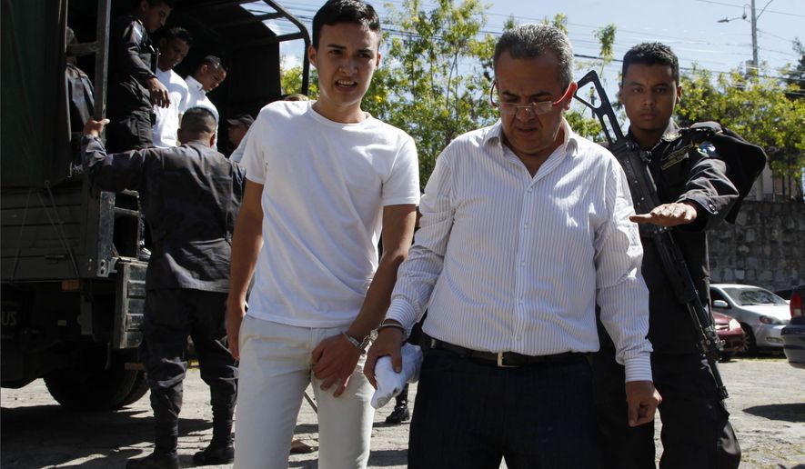 Elvin Rapalo, left, and Sergio Rodriguez, accused in the murder of Honduran indigenous and environmental rights activist Berta Caceres, are led in handcuffs to court by police in Tegucigalpa, Honduras, Thursday, Nov. 29, 2018. Rapalo, Rodriguez and other five accused were found guilty by a court and will be sentenced on January 2019. (AP Photo/Fernando Antonio)
