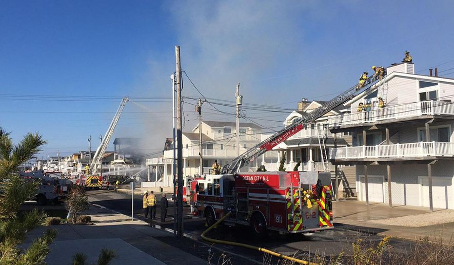 Firefighters battle a blaze at houses in Sea Isle City, N.J., Thursday, Nov. 29, 2018. Authorities say the fire has severely damaged at least a few homes and injured a few people. (Lauren Carroll/The Press of Atlantic City via AP)