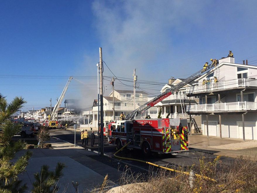 Firefighters battle a blaze at houses in Sea Isle City, N.J., Thursday, Nov. 29, 2018. Authorities say the fire has severely damaged at least a few homes and injured a few people. (Lauren Carroll/The Press of Atlantic City via AP)