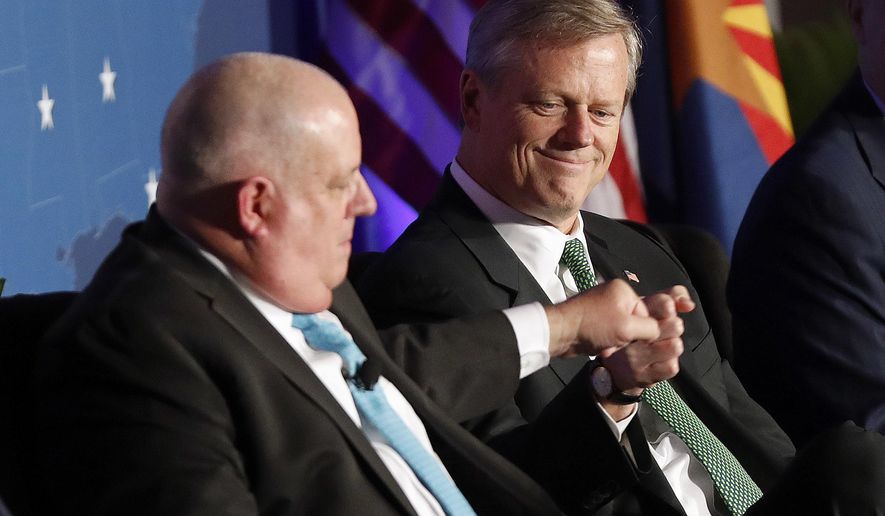 In this file photo, Maryland Gov. Larry Hogan, left, knuckles Massachusetts Gov. Charlie Baker, right, during the Republican Governors Association annual conference, Wednesday, Nov. 28, 2018, in Scottsdale, Ariz. Mr. Baker and Mr. Hogan were found by a Morning Consult survey to be the top two most popular governors in the United States in the second quarter of 2019, going off their approval ratings. (AP Photo/Matt York) **FILE**