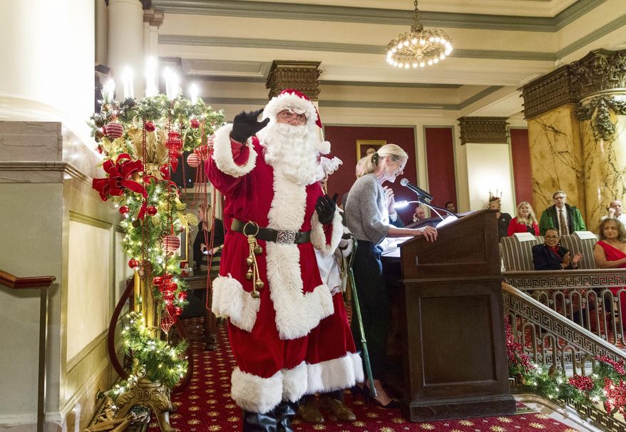 Mr. Santa Claus marches during the 32nd tree lighting ceremony at the Jefferson Hotel in Richmond on Monday Nov. 26, 2018. Andrew Boothby who portrayed Santa at Jefferson Hotel tree lighting Monday, died following the festivities. (Daniel Sangjib Min/Richmond Times-Dispatch via AP)